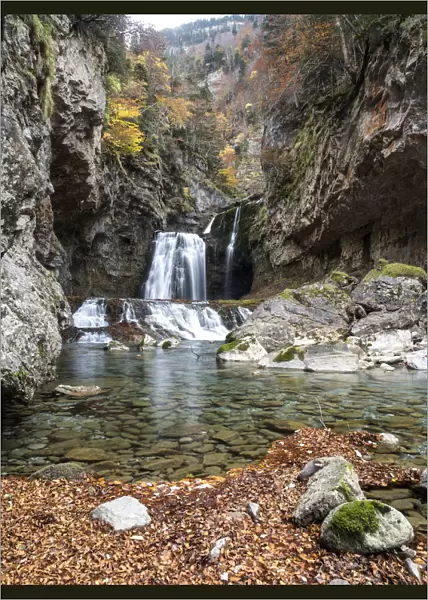 Waterfall in a forest in the Pyrenees in autumn