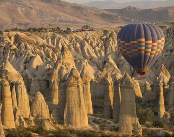Hot air balloon flying over rock landscape at Cappadocia Turkey
