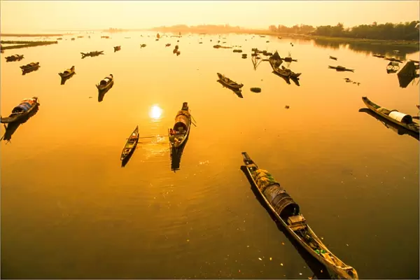 Boats in Tam Giang lagoon in sunrise from drone. Hue, Vietnam
