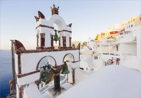 Orthodox church and its bell tower in Oia village, Santorini, Cyclades, Greece