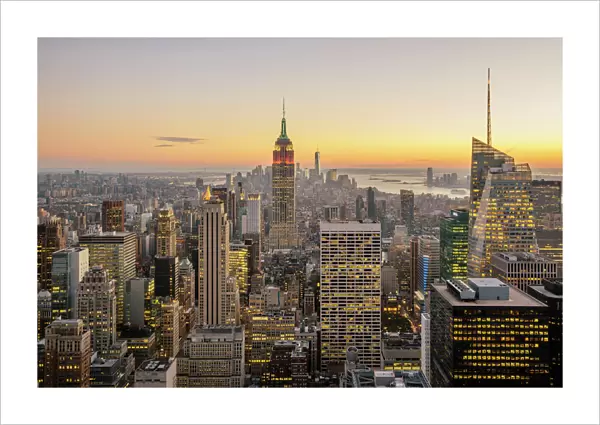 New York City skyline with illuminated skyscrapers seen from above during sunrise, New York State, USA