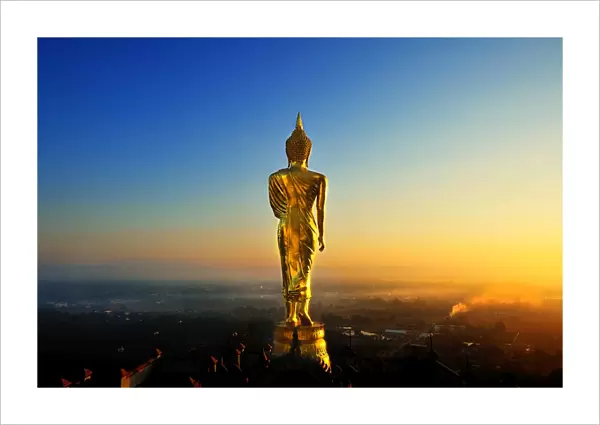 The golden standing buddha statue in Nan, Thailand