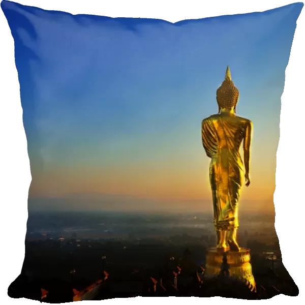 The golden standing buddha statue in Nan, Thailand
