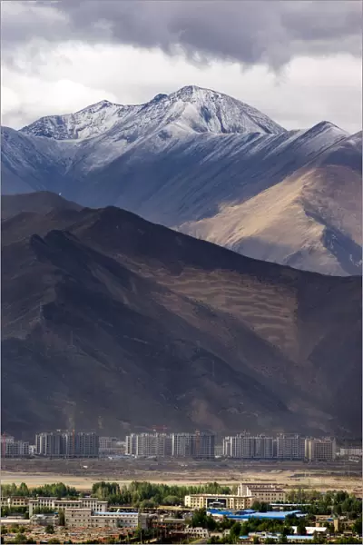 The enormous mountain range and the new city of Lhasa
