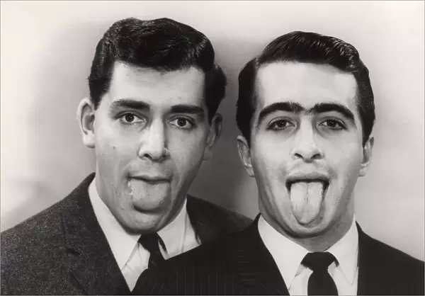 Close-up of two men with protruding tongues
