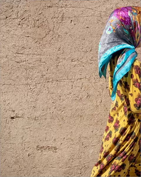Colorful dressed girl in Yazd adobe old town, Iran
