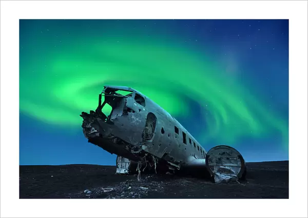 Aurora borealis over Douglas DC-3 Plane wreckage