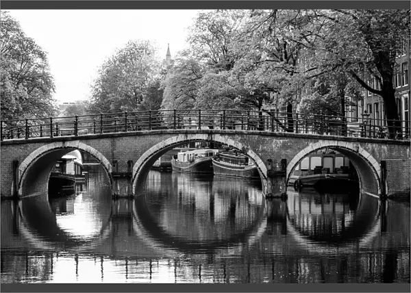Typical arch bridge in Amsterdam in black and white