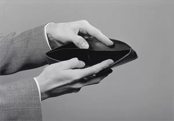 Mans hands holding open empty wallet. (Photo by H. Armstrong Roberts  /  Retrofile  /  Getty