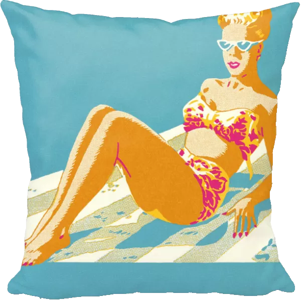 Woman in a Bikini Sitting on a Blanket