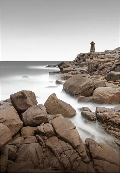 Long exposure of the Phare de Ploumanach lighthouse on the rugged coast of Brittany, France