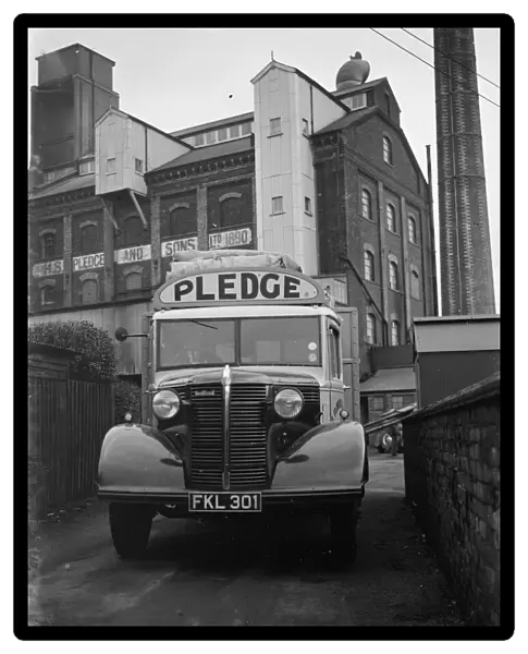 A loaded Bedford truck belonging to Pledge & Son Ltd, the milling company, pulls
