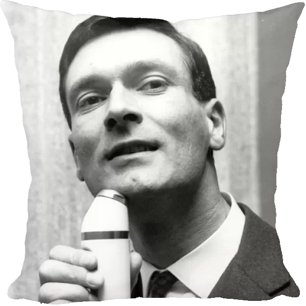 Elegant Shave Kenneth Grange of North London uses cordless electric shaver 22 May 1963