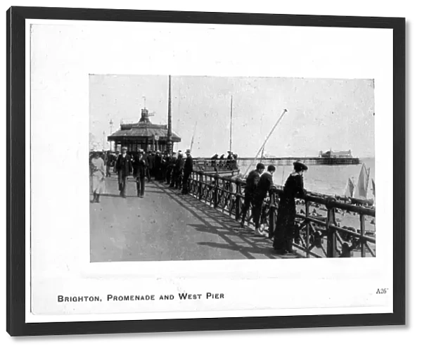 Some people walking along the seafront, Promenade and West Pier, Brighton, East Sussex