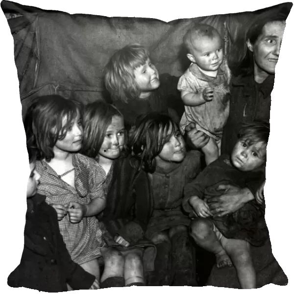 Mother with her seven children all looking very dirty 1948 photograph by John Topham