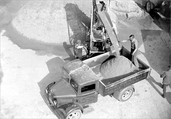 Bedford truck being loaded by a conveyor loader at the Sand & Gravel Co Ltd gray