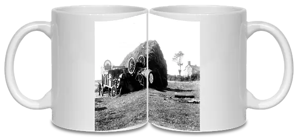 Threshing machine in collision with a hayrick. Possibly in St Stephen in Brannel, Cornwall. Around 1912