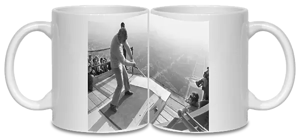 American Golfer Arnold Palmer kicks off from the second floor of the Eiffel Tower