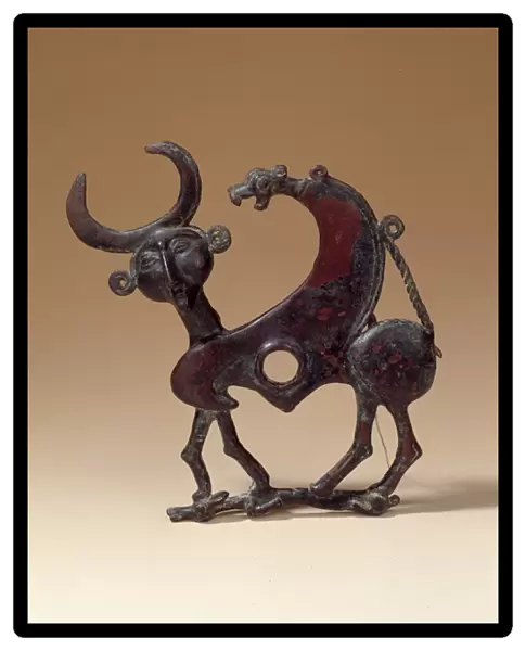 Oriental Antiquities: bronze jaw plate depicting an androcephalous monster trampling a