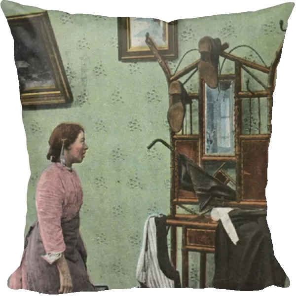 Maid clearing up a mans clothes (colour photo)
