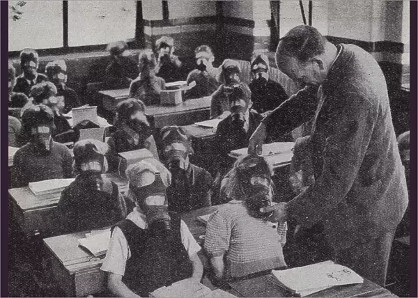 British schoolchildren practicing putting on their gas masks, World War II, 1939-1945 (b  /  w photo)