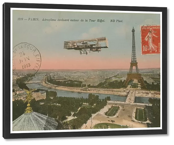 Postcard of an aeroplane circling around the Eiffel Tower, sent in 1913 (hand-coloured photo)