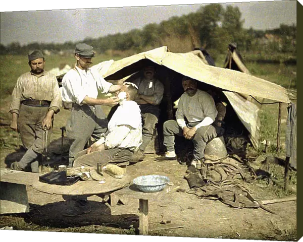 Soldier being shaved by a barber in a French military encampment, Soissons, Aisne, France