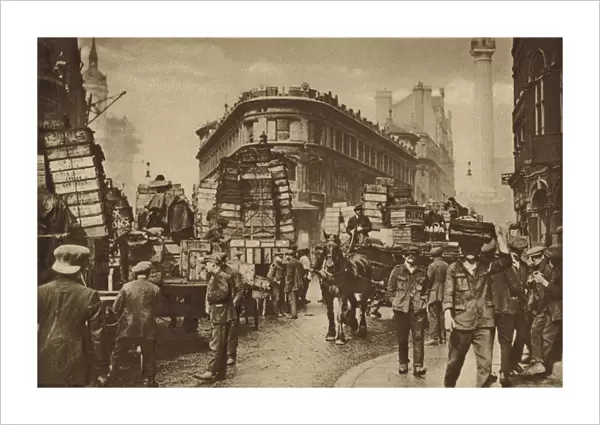 Fish-porters of Billingsgate gathered about consignments lately arrived from the coast (b  /  w photo)