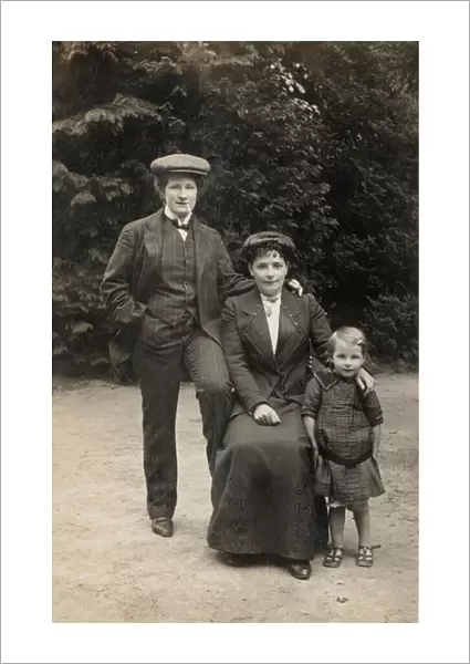 Two women, one dressed as man, with female child (b  /  w photo)