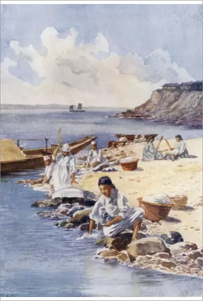 Korean women washing clothes in a river (colour litho)