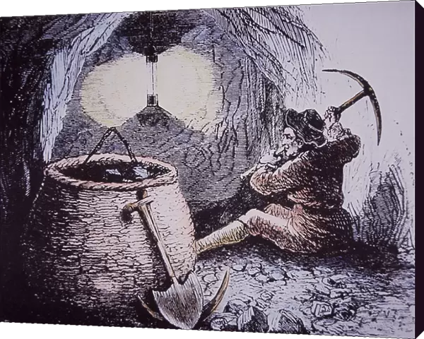 Coal miner working deep below ground by light of Davy Lamp, early 19th century (hand-coloured engraving)