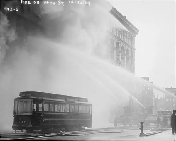 Firemen spraying burning building on 14th St. New York City, 1909 (b  /  w photo)
