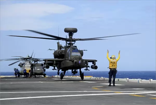 A U. S. Army AH-64E Apache Guardian launches from USS Peleliu