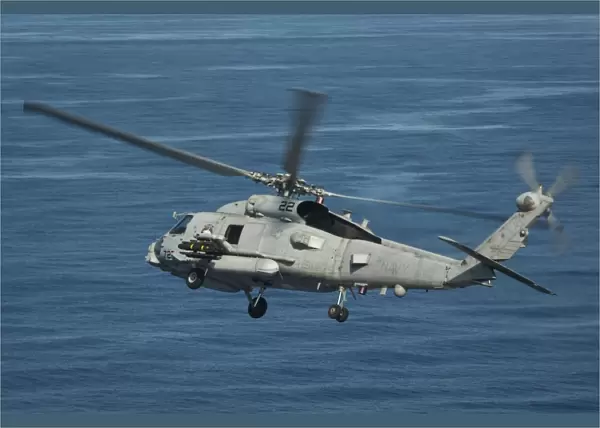 An MH-60R Sea Hawk maneuvers over the South China Sea