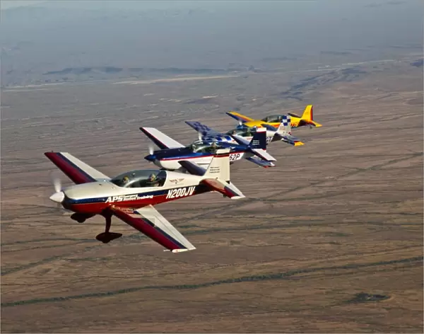 Extra 300 aerobatic aircraft fly in formation over Mesa, Arizona