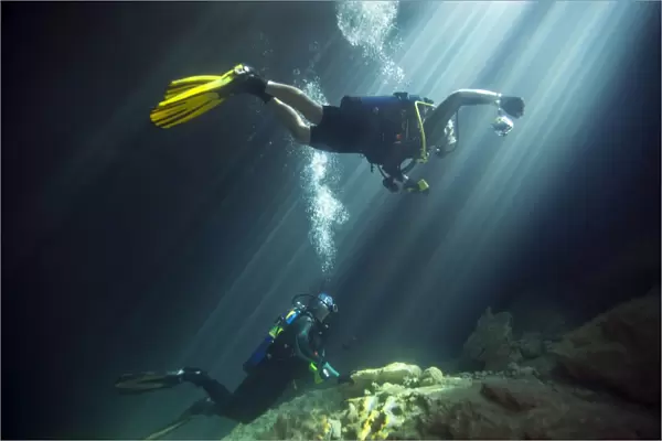 A young married couple scuba diving in Devils Den Springs Florida