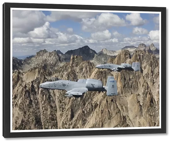 Two A-10 Thunderbolts fly over the mountains in Central Idaho