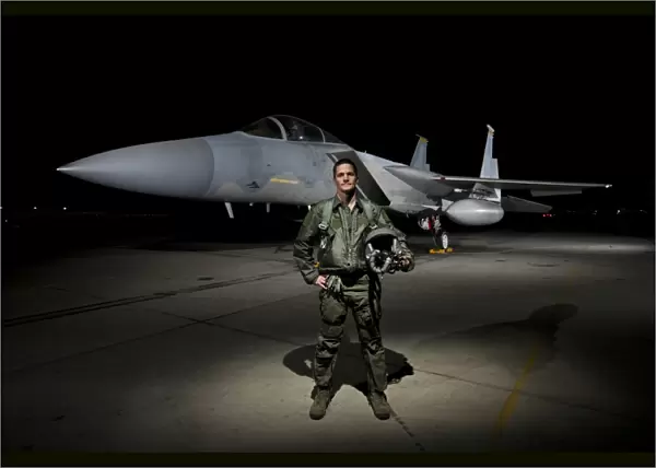 A U. S. Air Force pilot stands in front of a F-15C Eagle