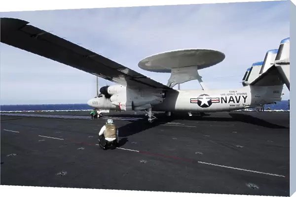 Sailors guide an E-2C Hawkeye to a steam driven catapult