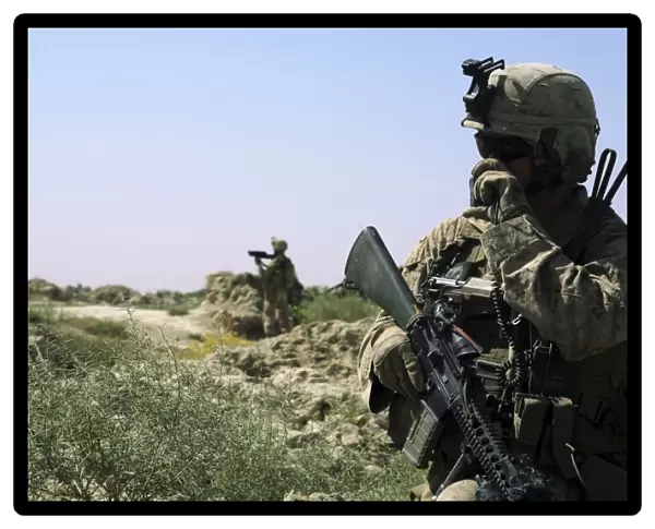 U. S. Marine uses a radio during a security patrol in Afghanistan