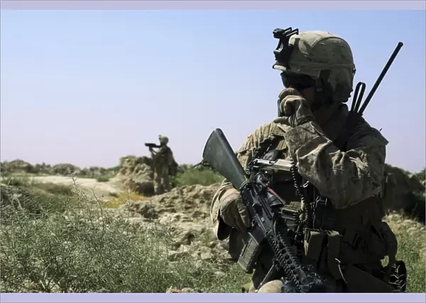 U. S. Marine uses a radio during a security patrol in Afghanistan