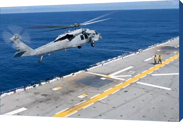 n MH-60S Sea Hawk helicopter lifts off the flight deck of USS Essex