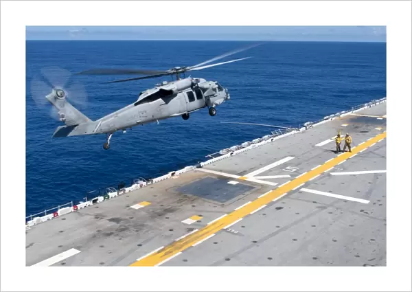 n MH-60S Sea Hawk helicopter lifts off the flight deck of USS Essex