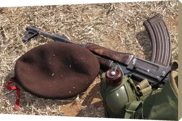 A rifle, military cover and canteen of a Mozambican soldier