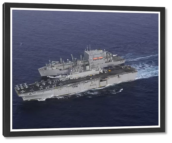 USS Kearsarge pulls alongside USNS Lewis and Clark for a replenishment at sea