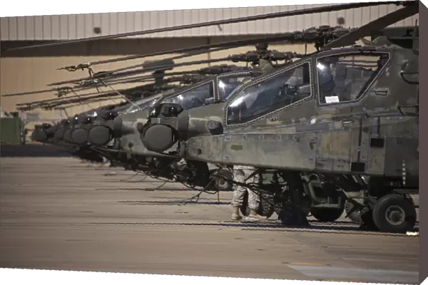 A row of AH-64D Apache helicopters at Pinal Airpark, Arizona