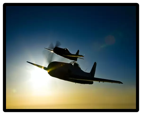 Silhouette of two Grumman F8F Bearcats in flight