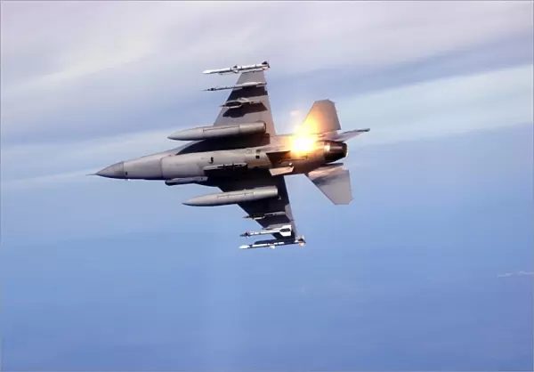 An F-16 Fighting Falcon drops flares while performing manuevers