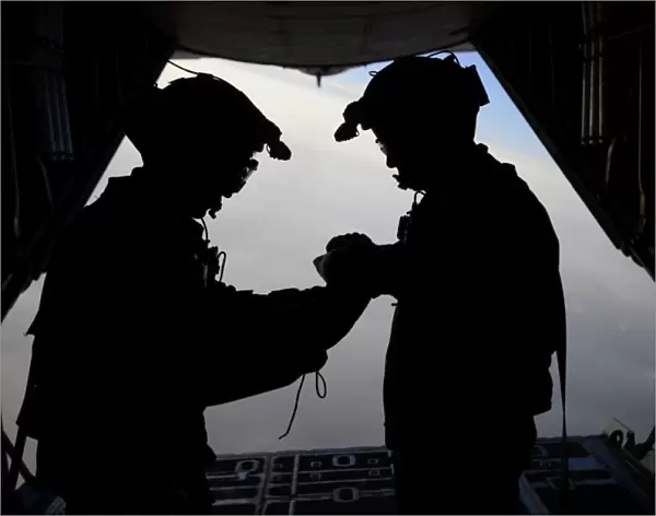 U. S. Air Force loadmasters fold the American flag aboard an HC-130 Hercules