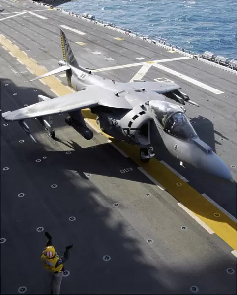 An AV-8B Harrier taxis forward after landing onboard USS Nassau